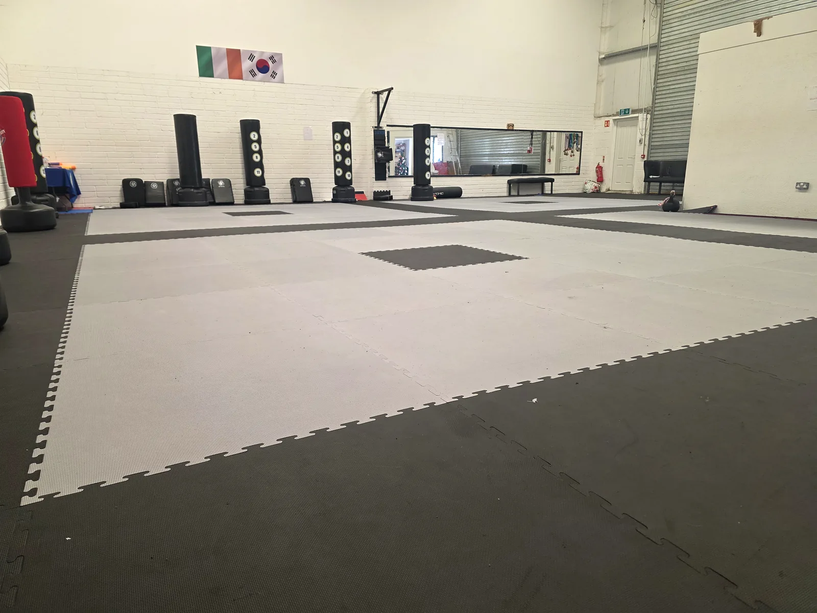 Irish and Korean flags on the wall above the matted training floor at Leinster TaeKwon Do Gorey